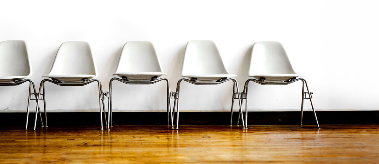 Row of empty chairs in a waiting room